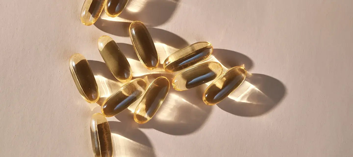 Translucent supplement capsules glistening in the light 